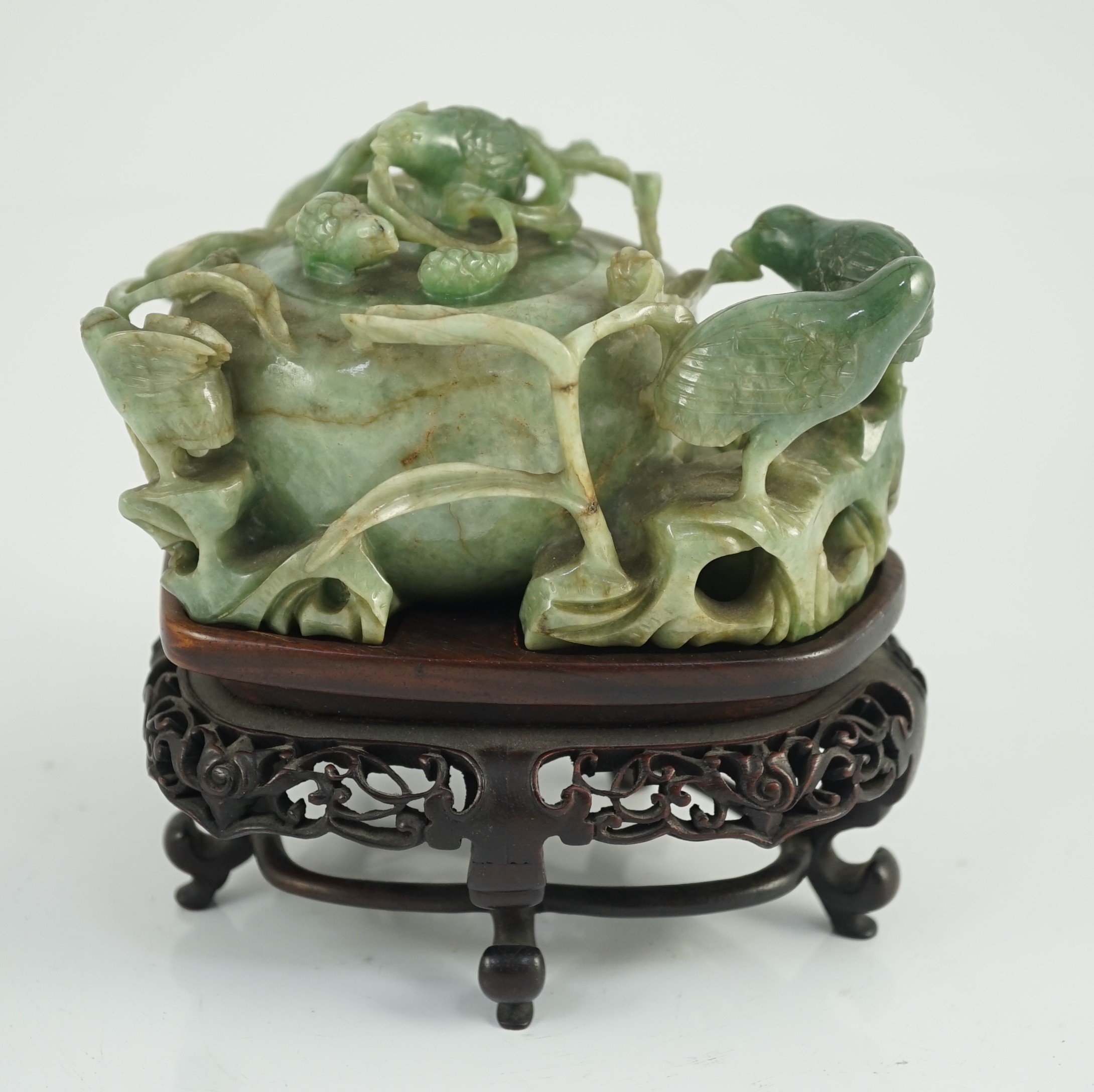 A Chinese jadeite ‘quail and millet’ water pot and stand, late 19th century, original carved and pierced wood stand, total width 15.2cm